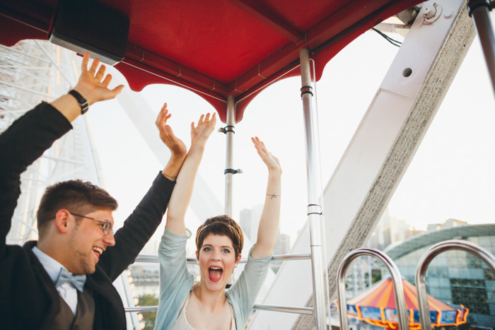 bride and groom on ferris wheel