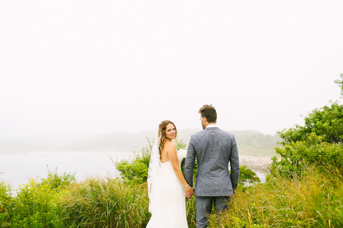 bride and groom walking down to the sea