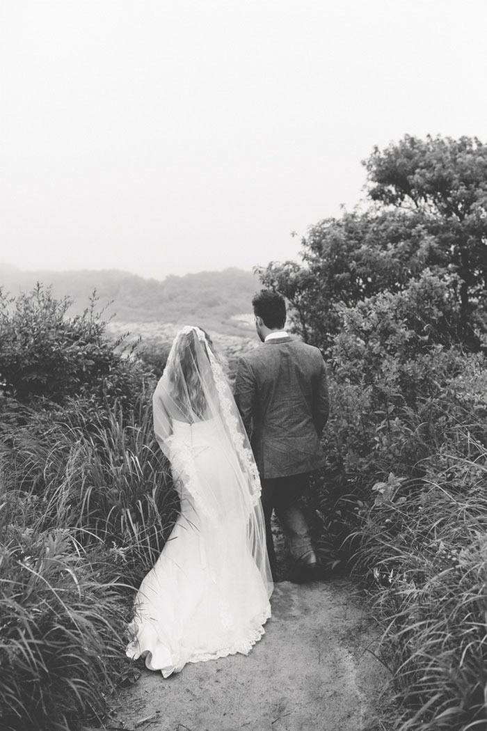 bride and groom walking down to the beach