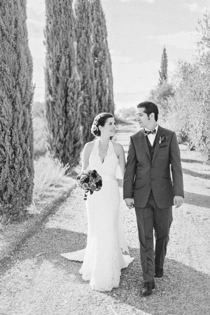 bride and groom walking in Tuscan countryside