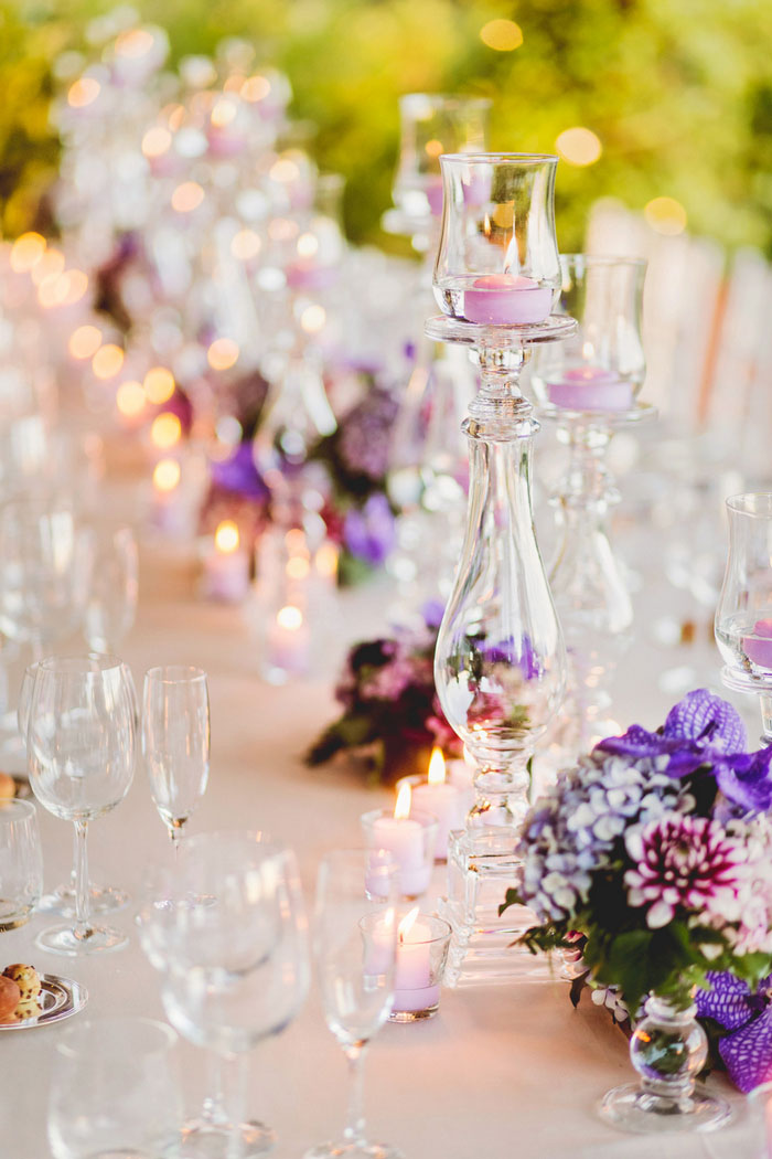 table setting with candles and purple flowers