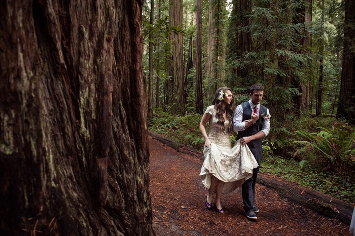 bride and groom walking in the woods