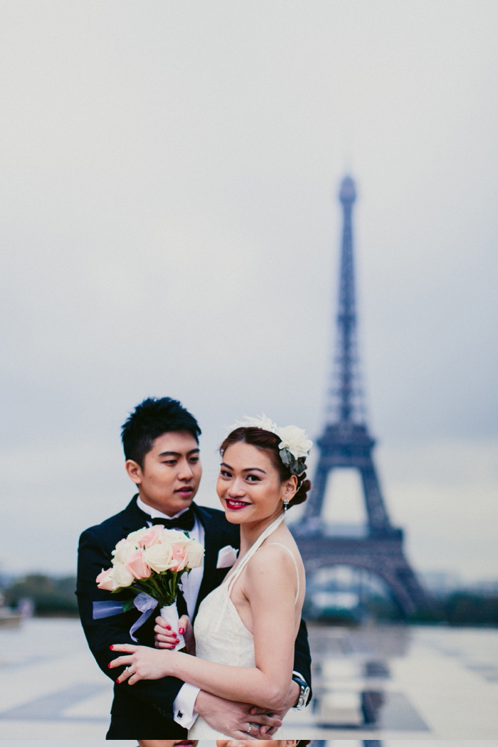 bride and groom in front of eiffel tower