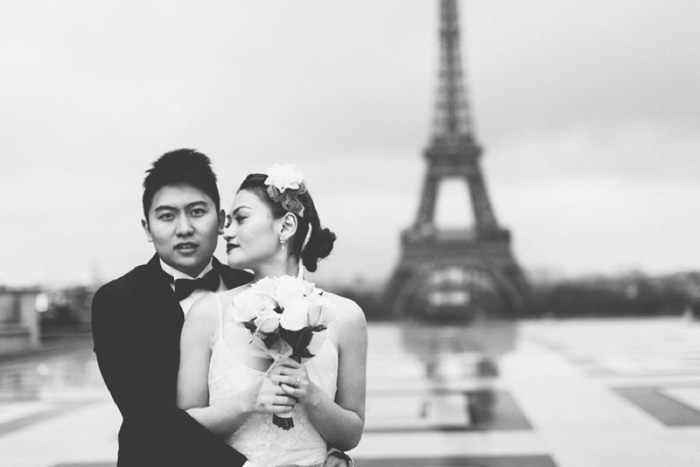 bride and groom in front of eiffel tower