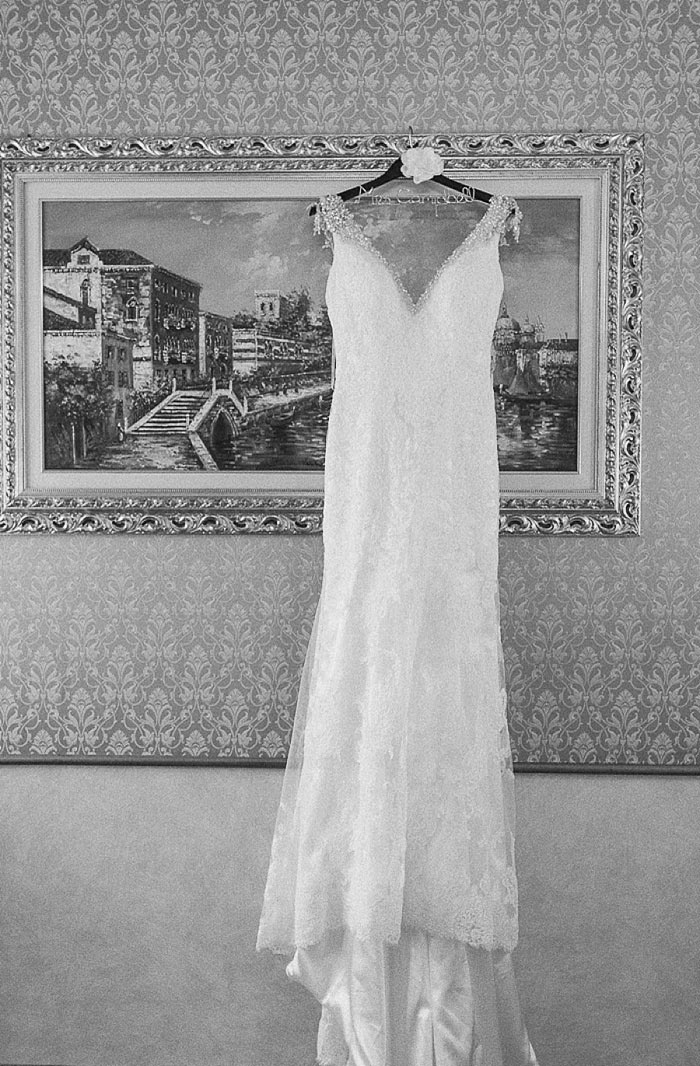 wedding dress hanging up in hotel room