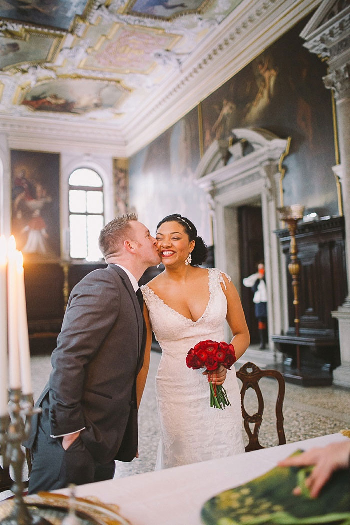 groom kissing his bride on the cheek