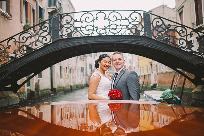 bride and groom on boat in Venice canal