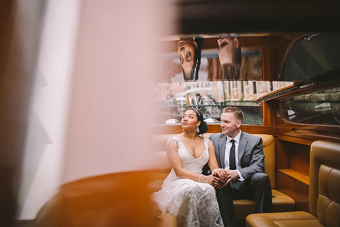 bride and groom riding in canal boat