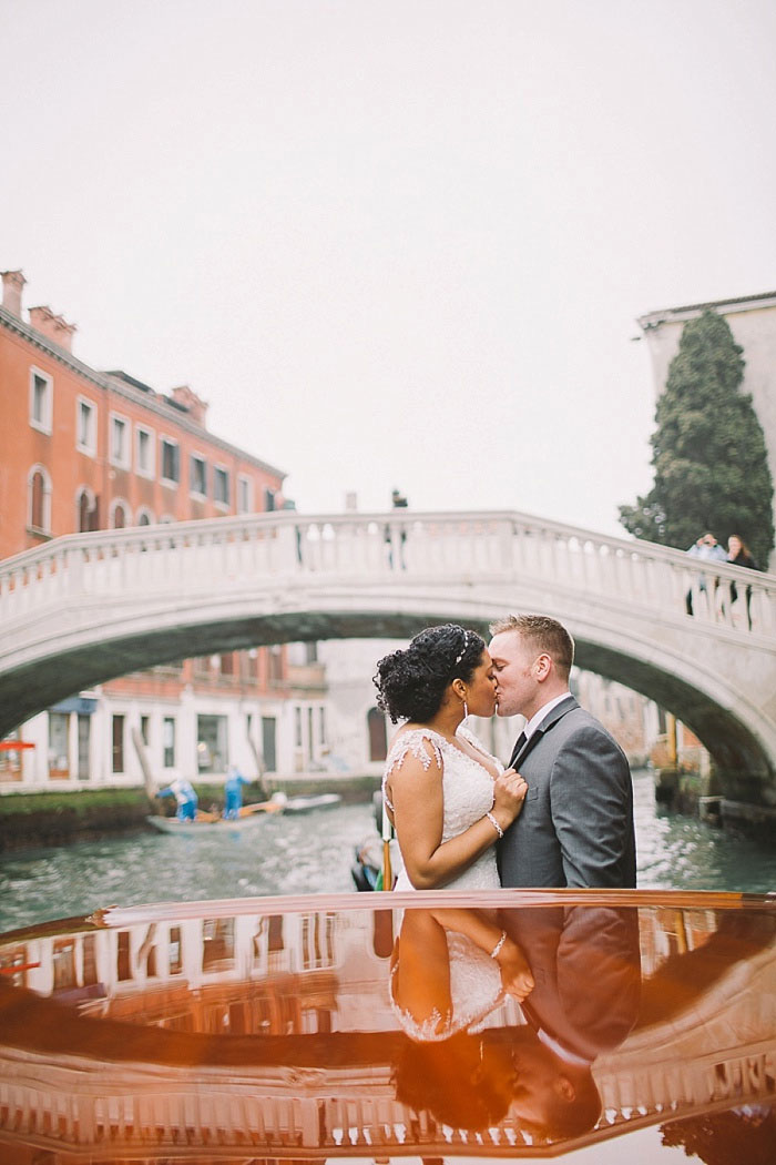 bride and groom kissing on canal boat