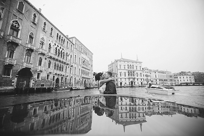 bride and groom kissing on Venice canal