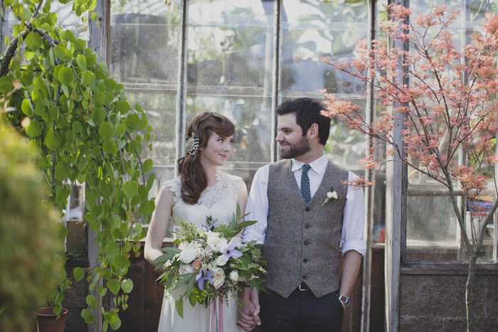 bride and groom portrait in greenhouse