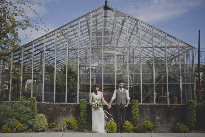 wedding portrait in front of greenhouse