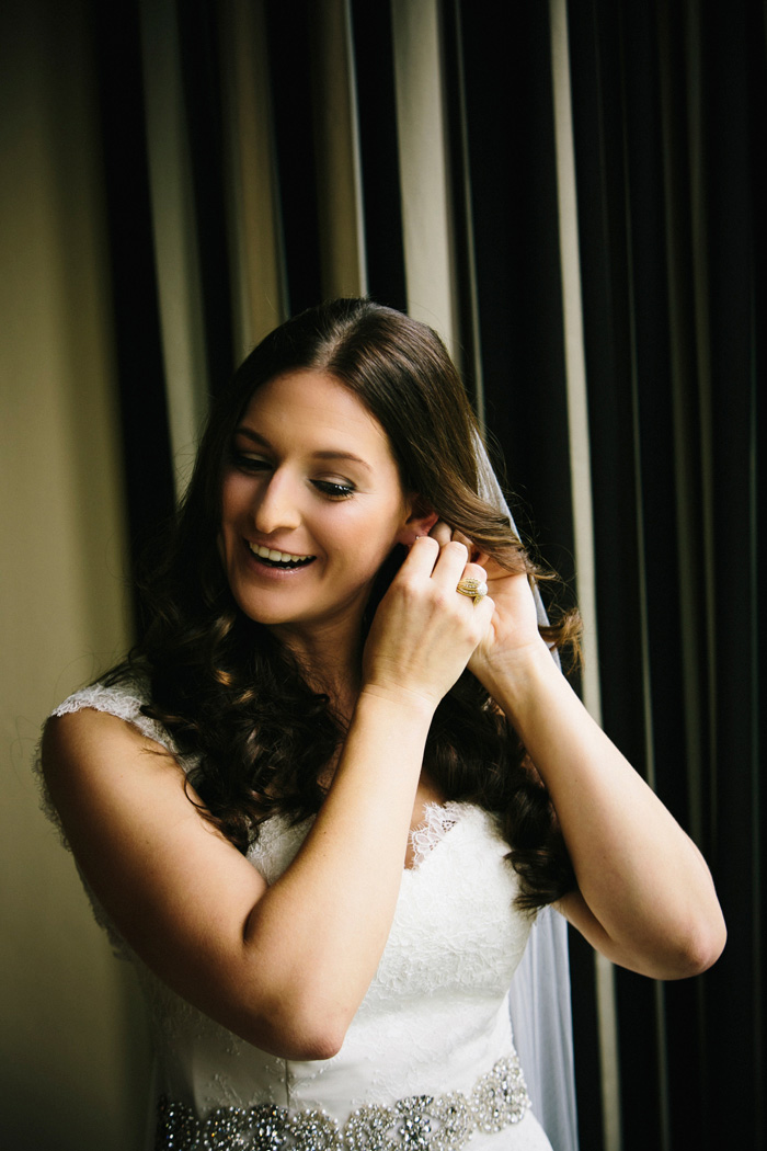 bride putting on earring