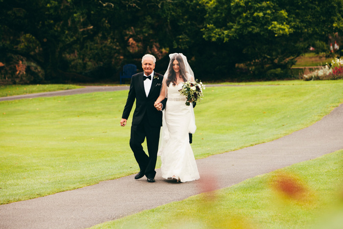 bride walking with her father to the aisle