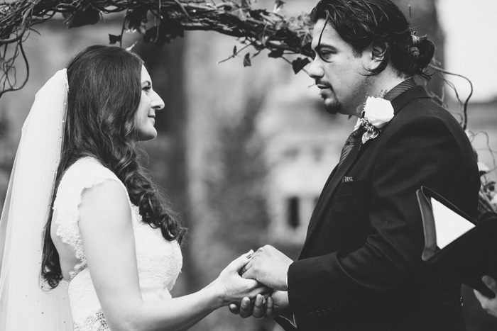 bride and groom holding hands during ceremony