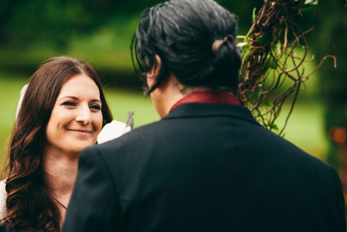 bride smiling at groom during ceremony