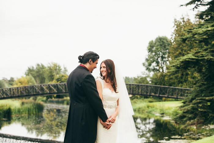 bride and groom portrait by pond