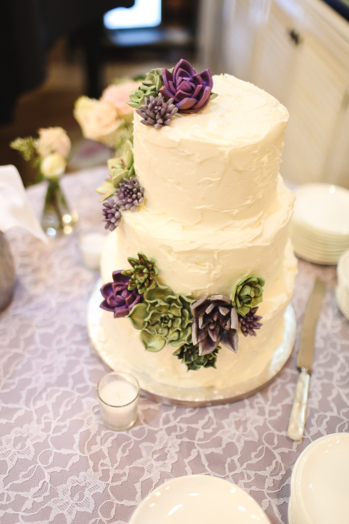 3-tier white wedding cake with succulents