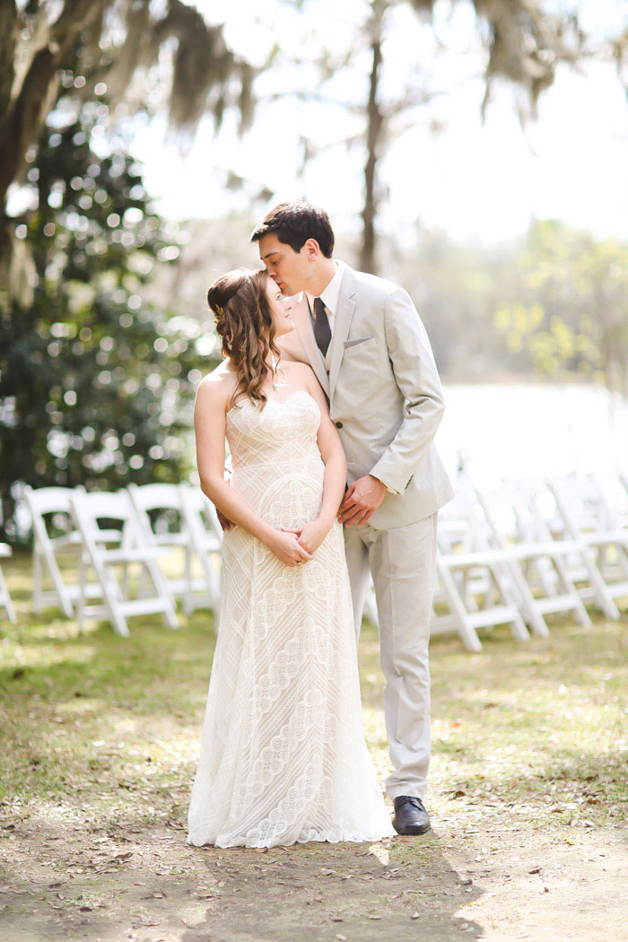 groom kissing bride's forehead