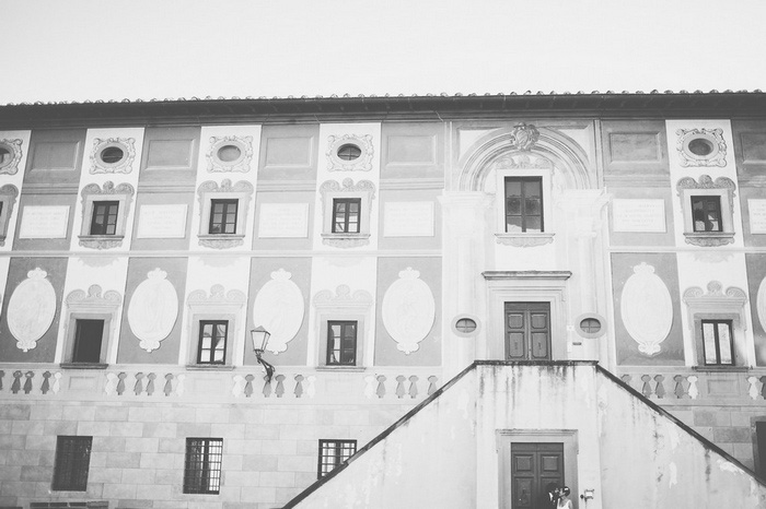 bride and groom portrait in front of Tuscan building