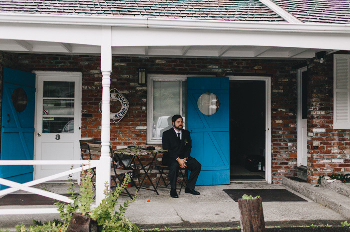 groom sitting on porch