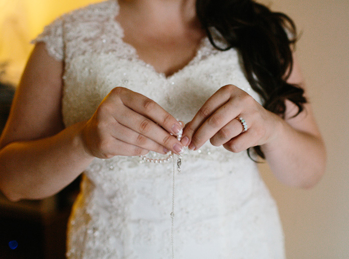 bride unclasping necklace