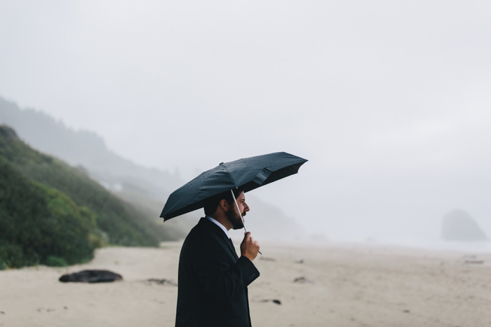 groom waiting on the beach under umbrella