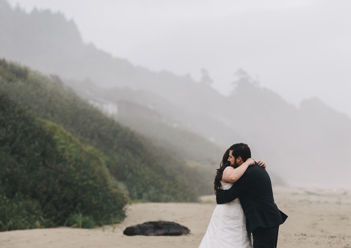 bride and groom hugging on the beach