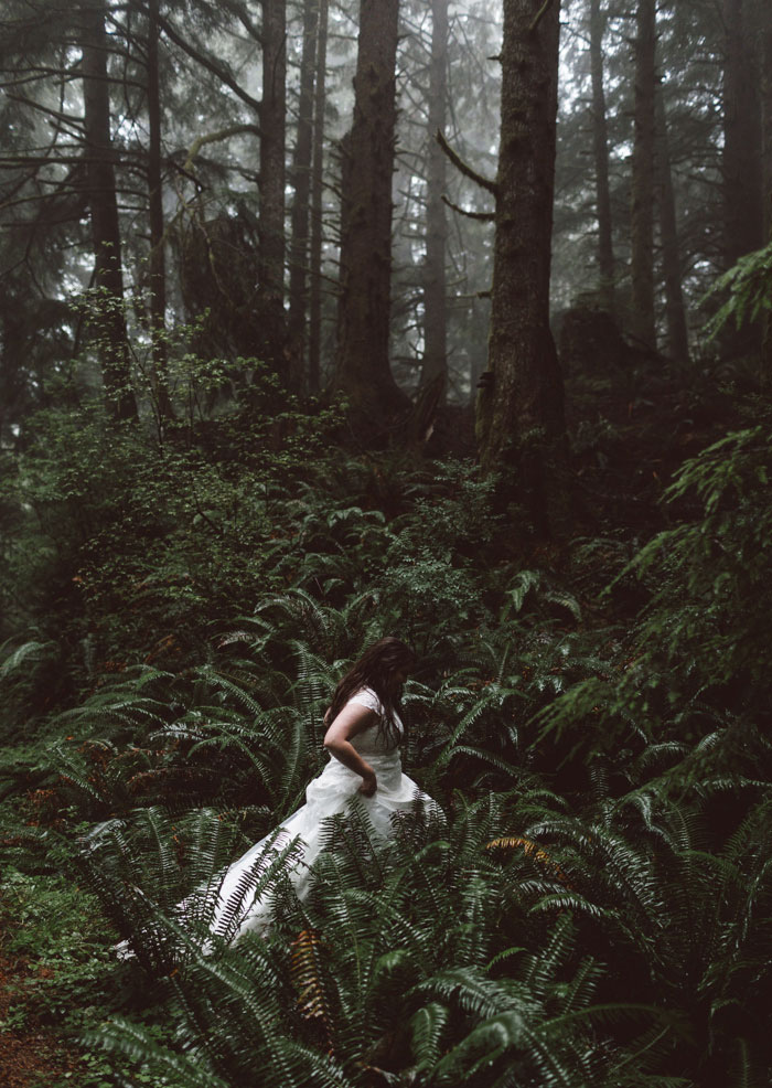 bride hiking through forest