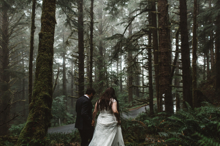 bride and groom walking in forest