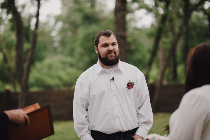 groom watching his bride walk down the aisle