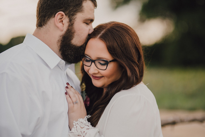 groom kissing bride's head