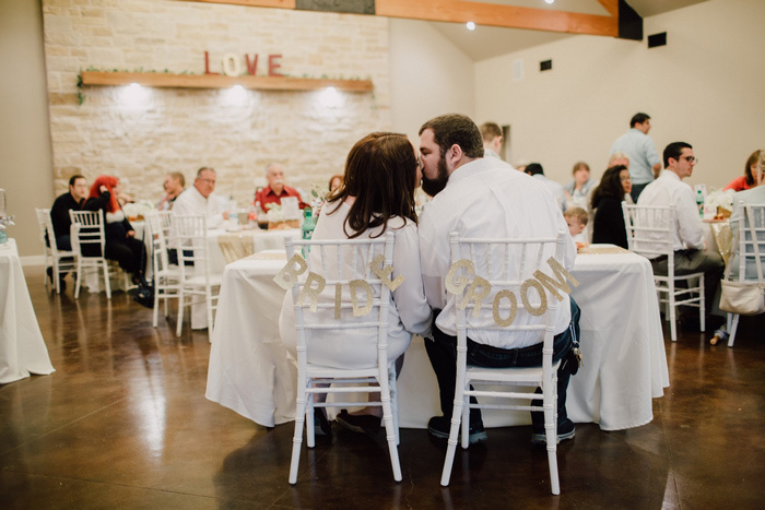 bride and groom kissing at reception