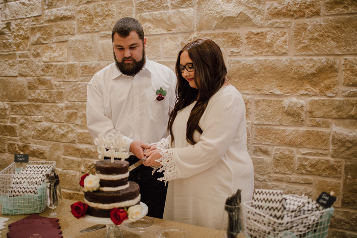 bride and groom cutting cake