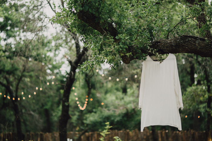 wedding dress hanging in trees