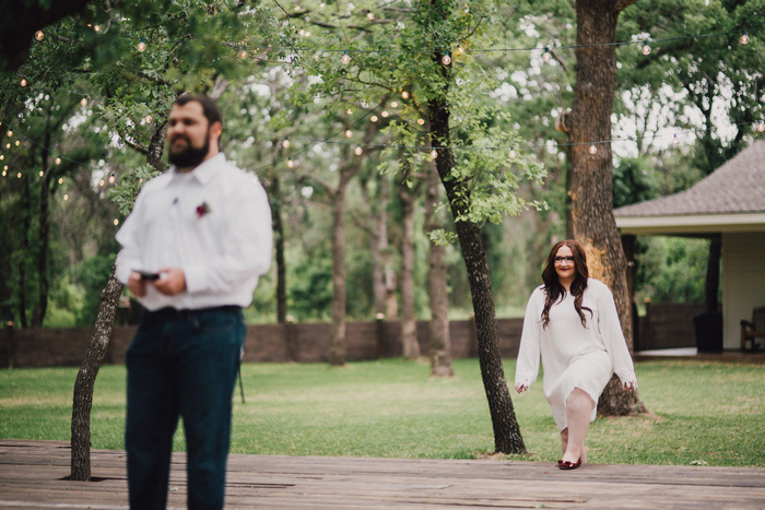 bride walking up behind groom