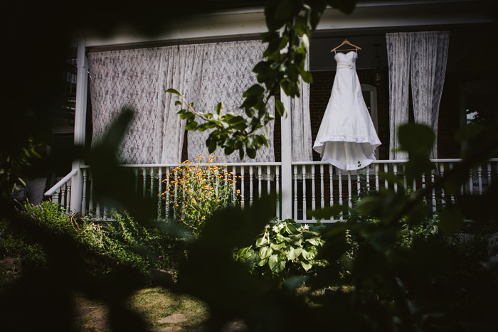 wedding dress hanging on porch