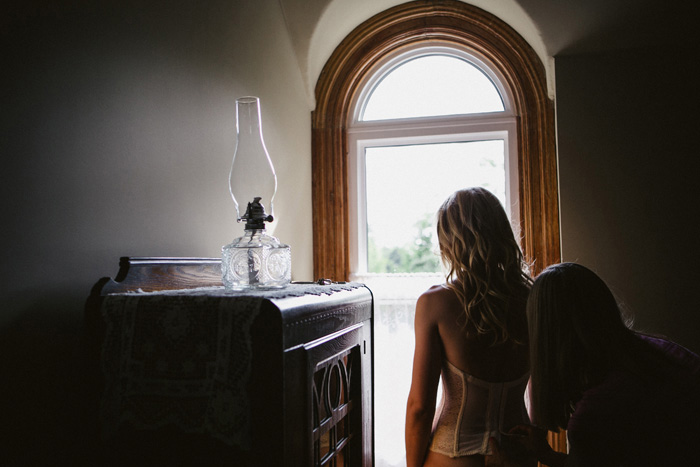 bride getting her corset laced up