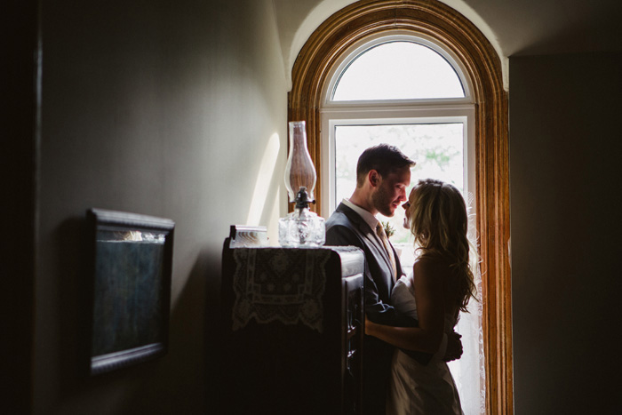 bride and groom portrait by window