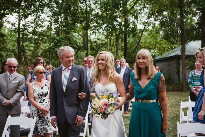 bride walking down the aisle with her parents