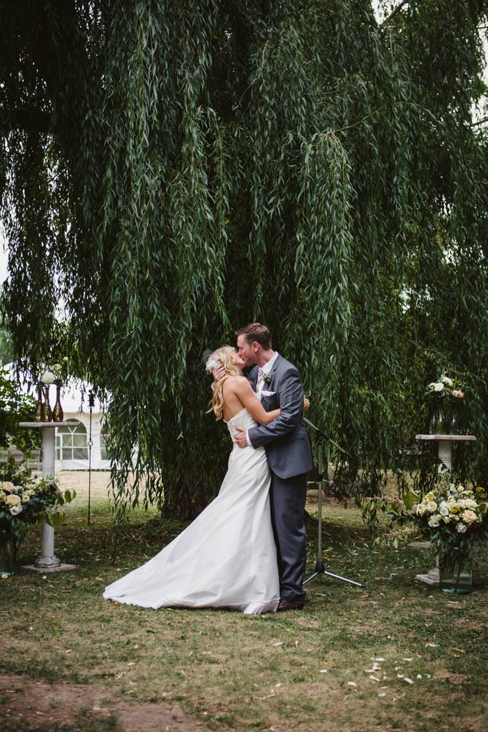 bride and groom first kiss