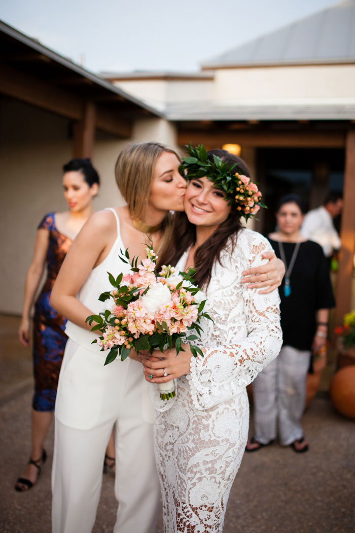 maid of honor kissing bride