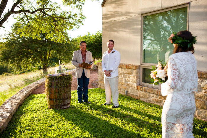 groom watching bride walk down the aisle