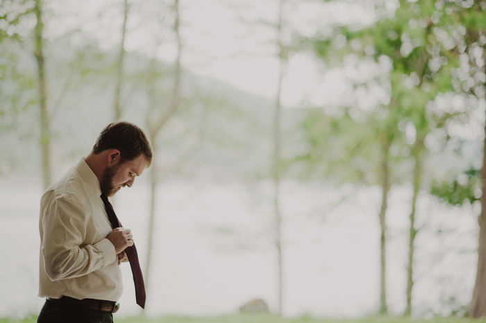 groom tying tie