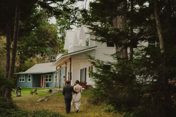 bride and groom walking toward house