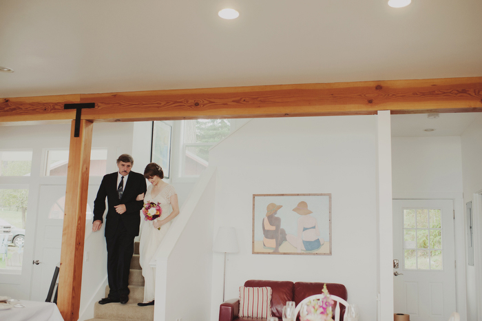 bride walking down stairs with father