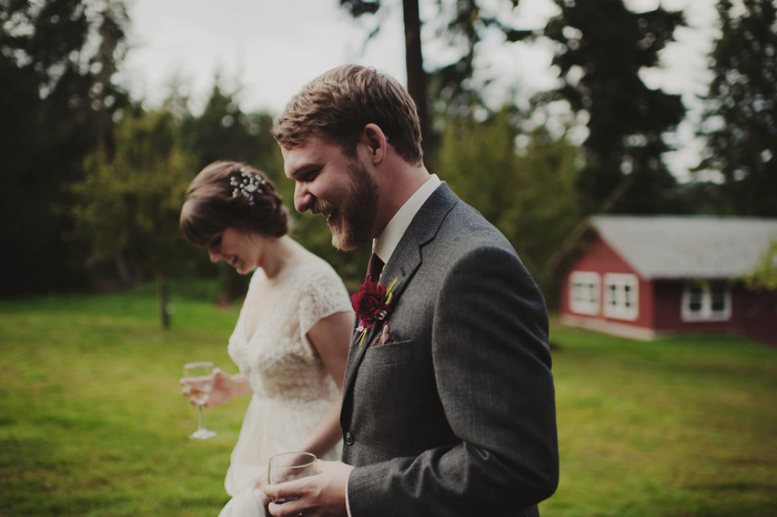 bride and groom walking with wine glasses