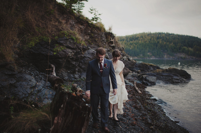 bride and groom walking on rocks