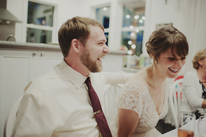 bride and groom laughing at reception