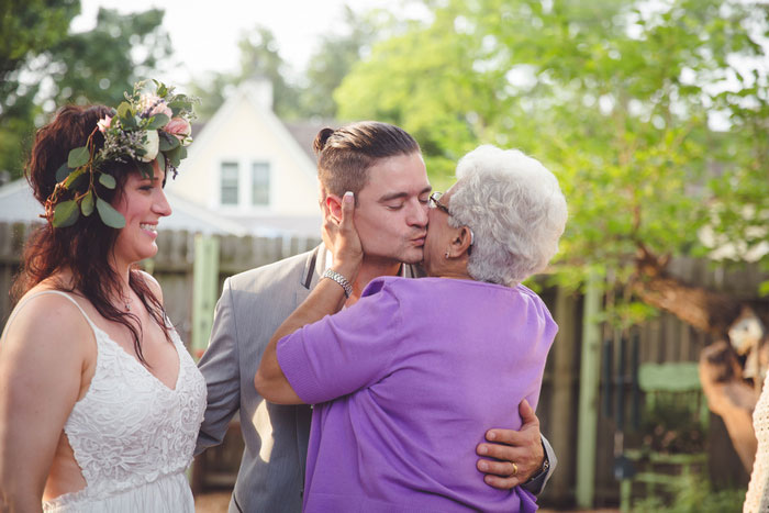 groom kissingwedding guest